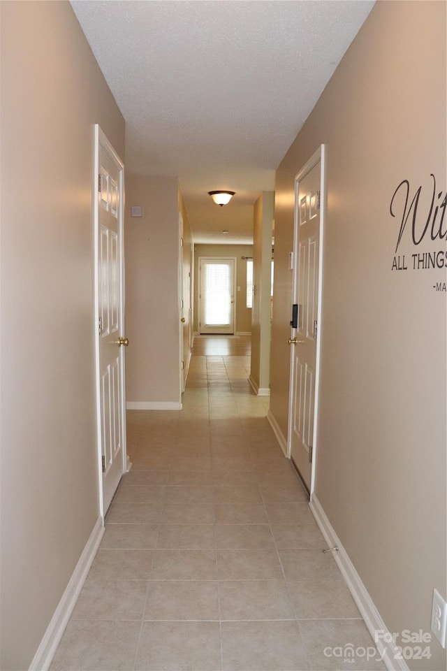 corridor featuring light tile patterned flooring