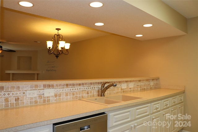 kitchen with sink, stainless steel dishwasher, decorative light fixtures, decorative backsplash, and ceiling fan with notable chandelier