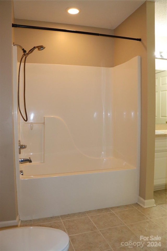 bathroom featuring tile patterned flooring, shower / bathing tub combination, and vanity