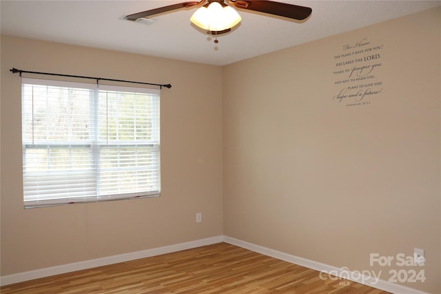 empty room featuring hardwood / wood-style flooring and ceiling fan