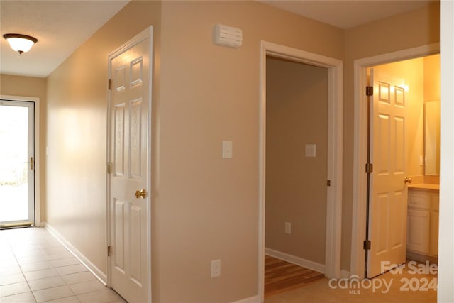 hall with light tile patterned flooring