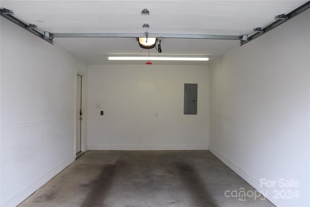 garage featuring a garage door opener and electric panel