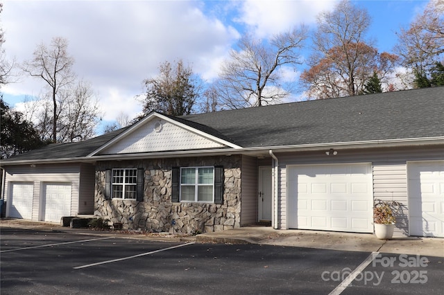 view of front of house with stone siding and a garage