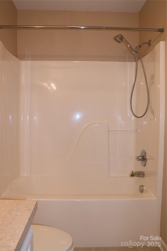 bathroom featuring toilet, shower / tub combination, and vanity