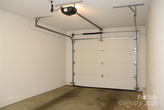 garage with baseboards and a garage door opener