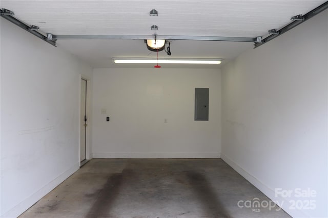 garage featuring baseboards, a garage door opener, and electric panel