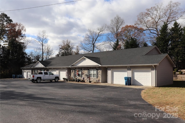 single story home with driveway and a garage