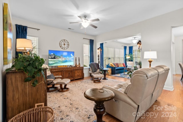 living room with plenty of natural light, ceiling fan, and light hardwood / wood-style flooring