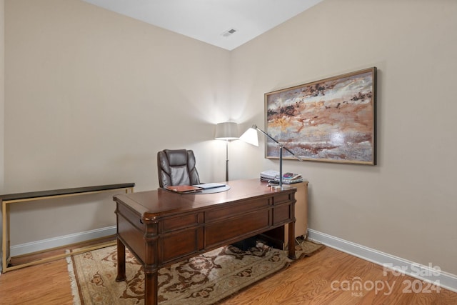 office with light hardwood / wood-style flooring