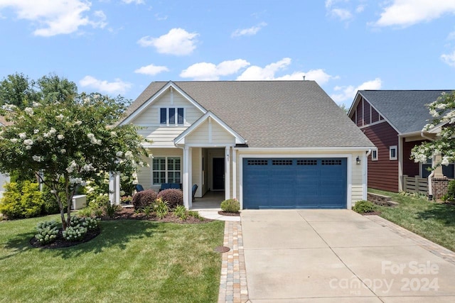 view of front of house featuring a front yard and a garage