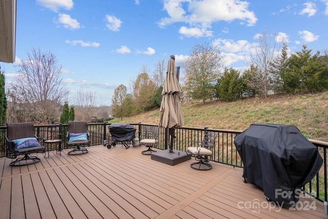 wooden deck featuring area for grilling