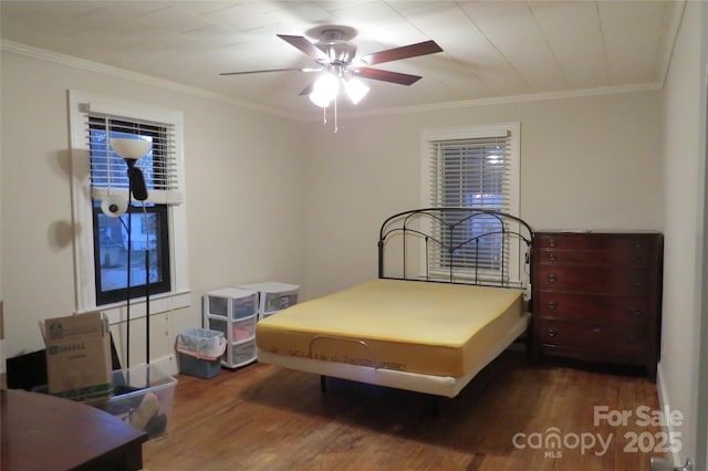 bedroom featuring crown molding, ceiling fan, and wood finished floors