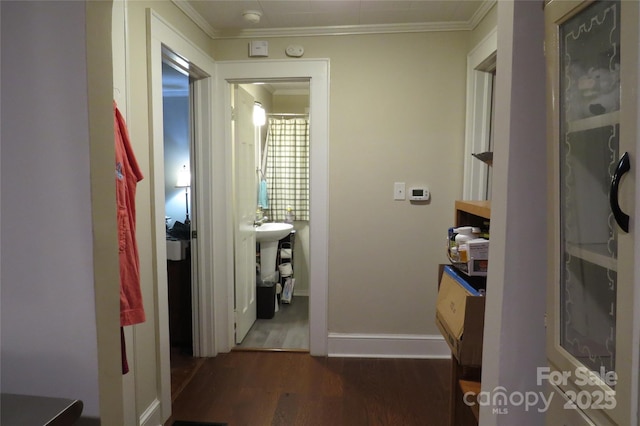 hall with baseboards, dark wood-style flooring, and crown molding