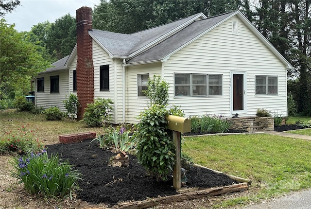 155 6th St SW, Taylorsville, NC 28681 - view of front of property featuring roof with shingles, a chimney, and a front lawn