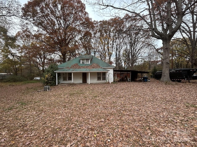 view of front of home with covered porch and a carport