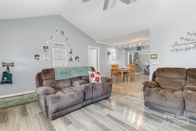 living room featuring light wood-type flooring, track lighting, vaulted ceiling, and ceiling fan