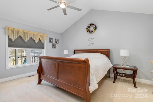 bedroom with ceiling fan, light colored carpet, and vaulted ceiling