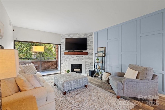 living room with a fireplace and light hardwood / wood-style flooring