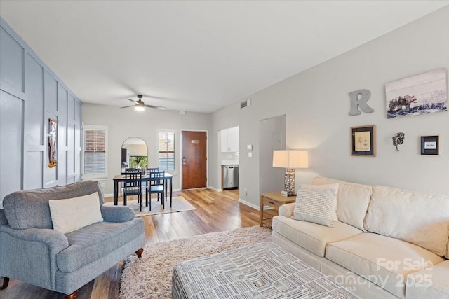 living room featuring ceiling fan and light hardwood / wood-style flooring