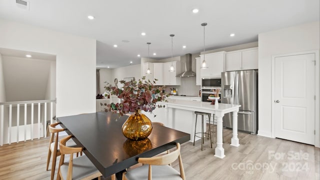 dining space featuring light wood-type flooring