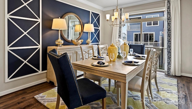 dining space with ornamental molding, dark wood-type flooring, and an inviting chandelier