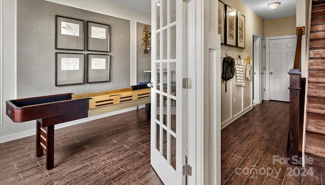 corridor with french doors and dark hardwood / wood-style floors