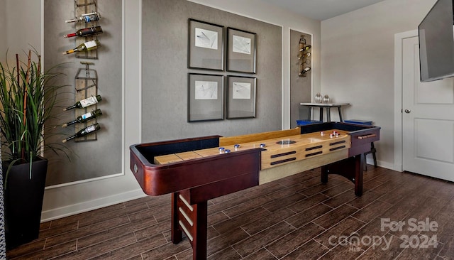 recreation room with dark hardwood / wood-style floors