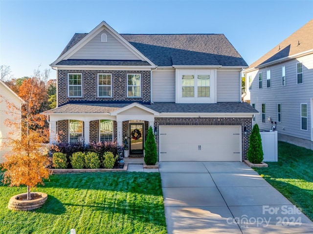 view of front of house featuring a front yard and a garage