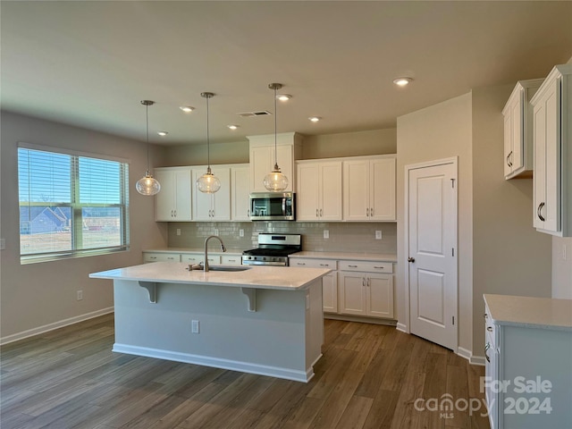 kitchen featuring sink, white cabinets, dark wood-type flooring, and appliances with stainless steel finishes