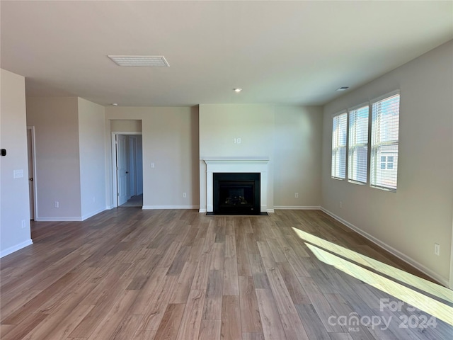 unfurnished living room featuring hardwood / wood-style flooring