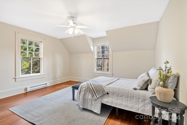 bedroom with hardwood / wood-style flooring, ceiling fan, lofted ceiling, and a baseboard heating unit