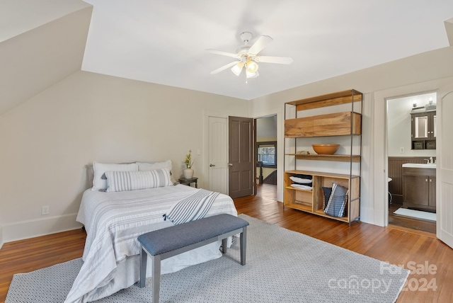 bedroom featuring connected bathroom, dark hardwood / wood-style floors, ceiling fan, and sink