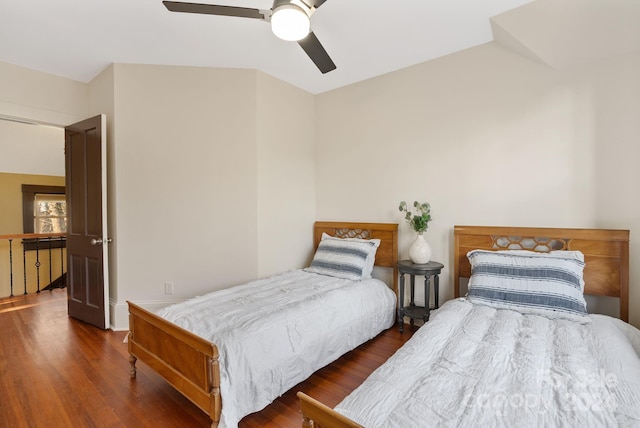 bedroom with ceiling fan and dark wood-type flooring