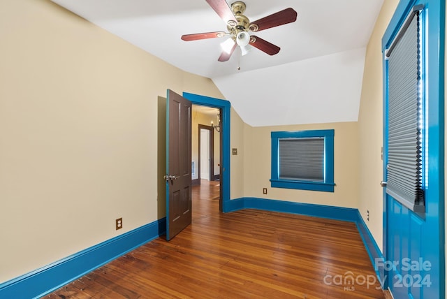 unfurnished bedroom featuring a closet, hardwood / wood-style flooring, vaulted ceiling, and ceiling fan