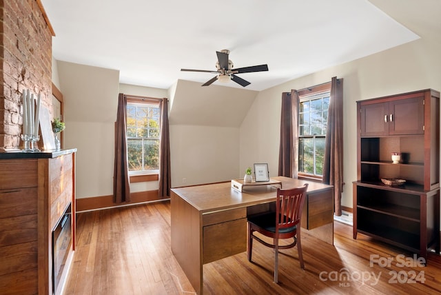 office space with ceiling fan, vaulted ceiling, and light hardwood / wood-style flooring