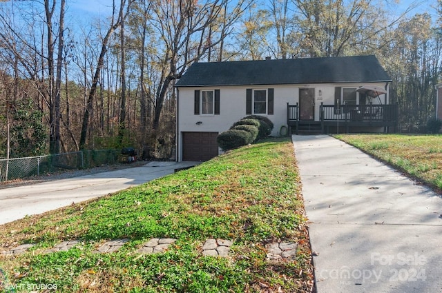 view of front of home with a front yard and a garage