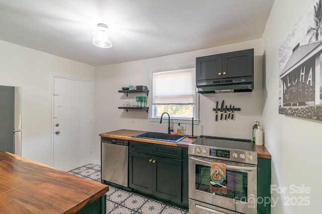 kitchen with sink, stainless steel appliances, and wood counters