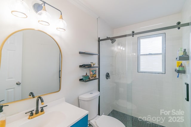 bathroom with ornamental molding, a shower with door, toilet, and vanity