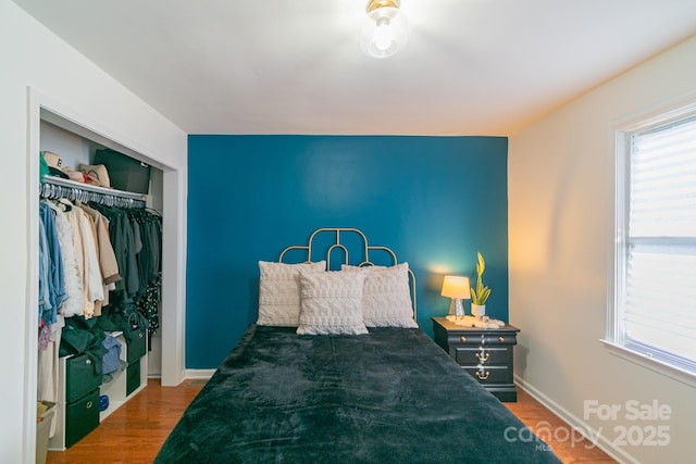 bedroom featuring dark wood-type flooring and a closet