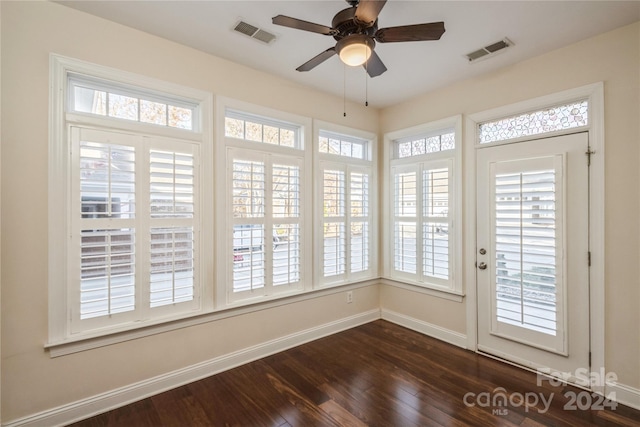 unfurnished sunroom with ceiling fan