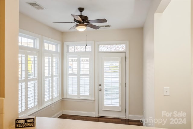 doorway featuring ceiling fan and dark wood-type flooring