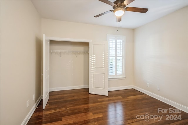 unfurnished bedroom featuring a closet, dark hardwood / wood-style floors, and ceiling fan