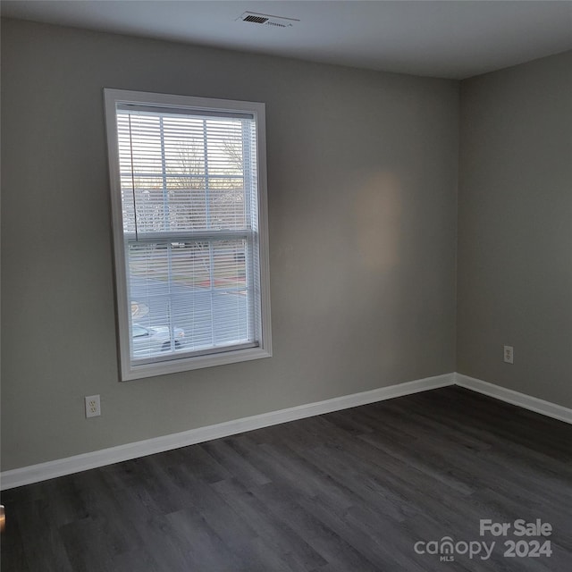 spare room with dark hardwood / wood-style flooring