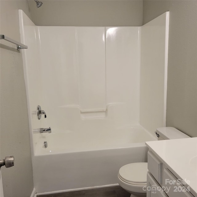 full bathroom with hardwood / wood-style flooring, vanity, toilet, and shower / tub combination