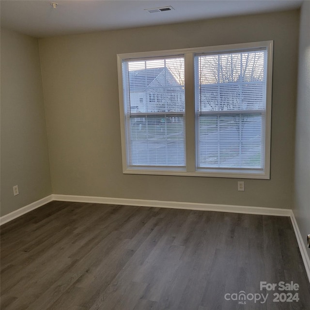 unfurnished room featuring dark hardwood / wood-style floors