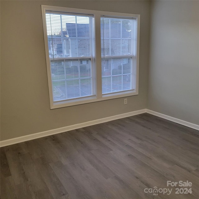 empty room with dark wood-type flooring