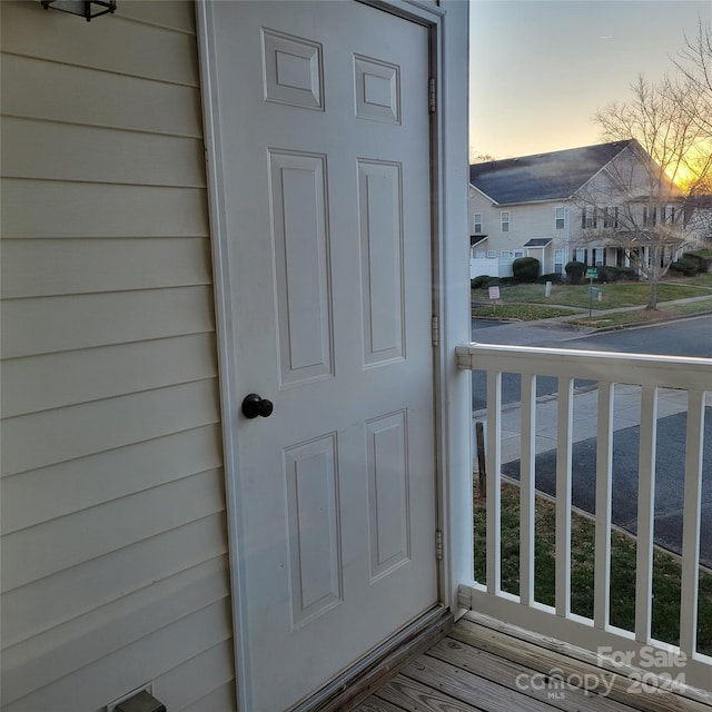 exterior entry at dusk featuring covered porch