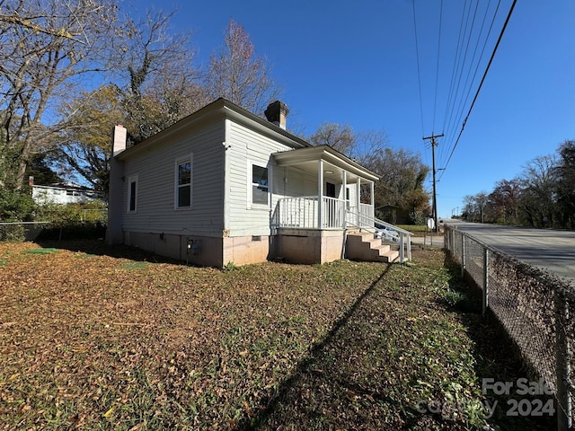 view of side of home with a porch