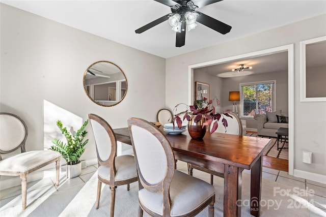 tiled dining room featuring ceiling fan