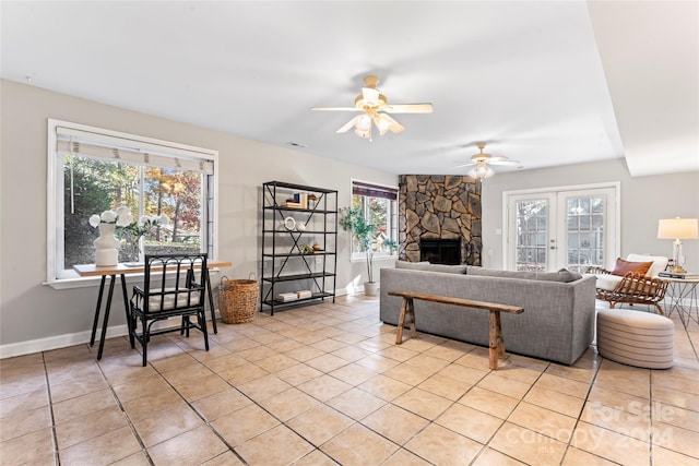 living room featuring ceiling fan, a healthy amount of sunlight, and light tile patterned floors